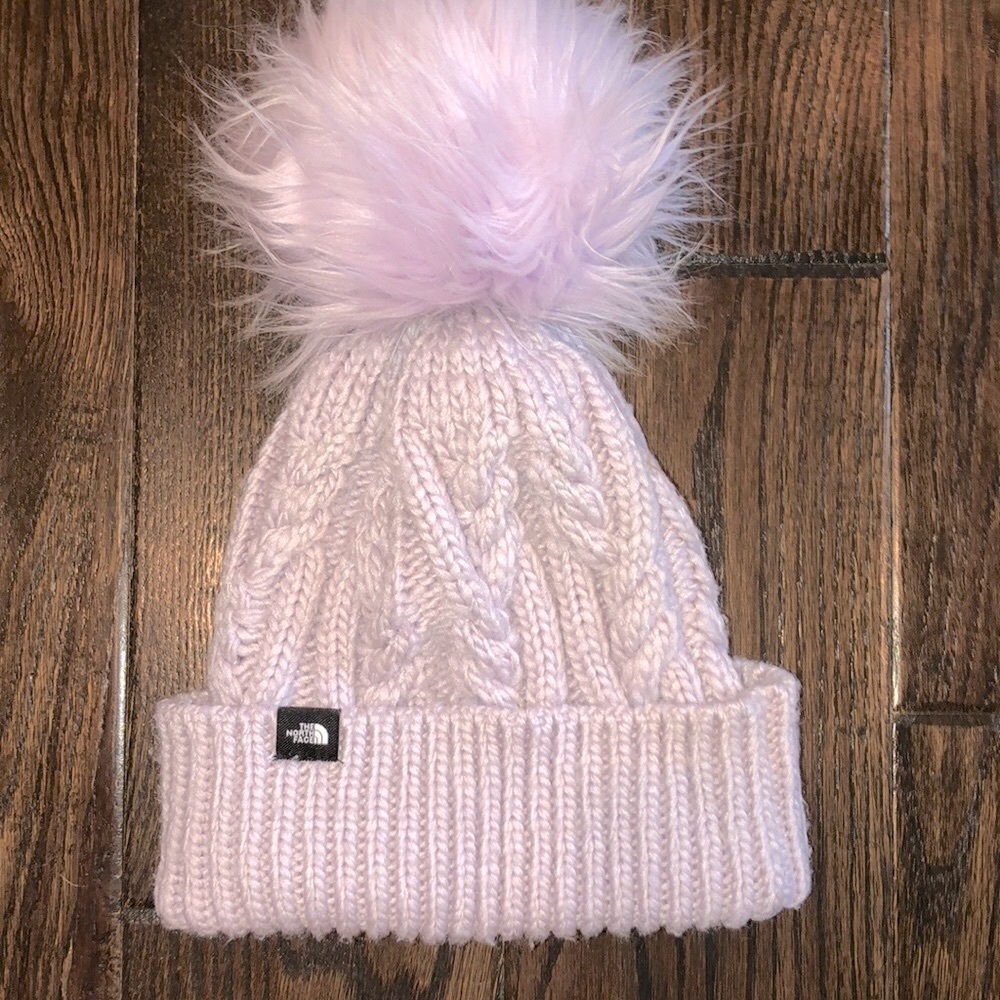 The north face lavender color beanie hat with large fluff Pom Pom